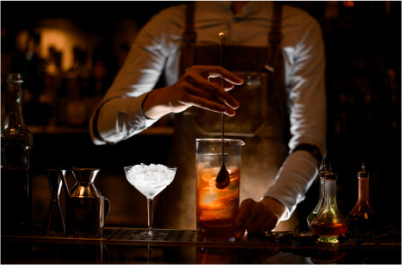 Image of a mixologist preparing a cocktail