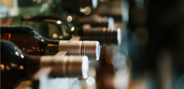 image of wine bottles in a wooden rack